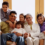 Image of family sitting on a sofa smiling