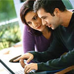 Image of a man and woman viewing a laptop computer