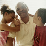 Image of a man with two kids
