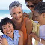 Image of women smiling on the beach