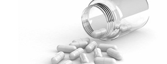 Photograph of spilled bottle of pills.