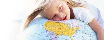 Photograph of child on globe.