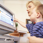 Image of a woman and a child in front of a computer