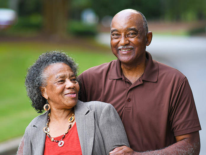 A man with a Medicare plan who has spousal benefits, spending time with his wife