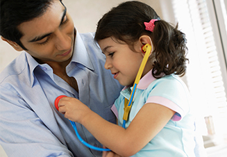 child playing with stethoscope