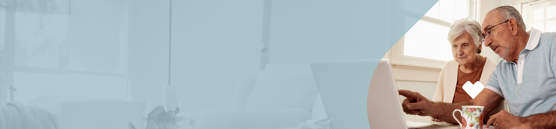 A man and woman looking at a laptop and learning about their Medicare dental, vision and hearing aid coverage 