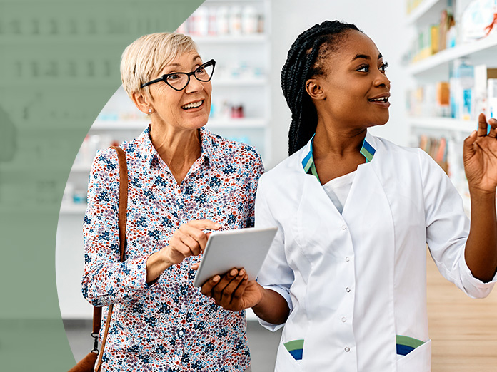 Image of a female pharmacist helping an old woman find over the counter products