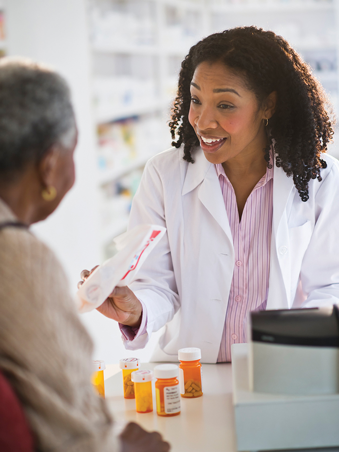 Pharmacist showing medication to a patient 