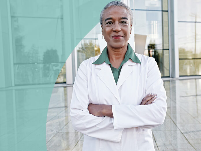 Professional Nurse Standing with Arms Folded | Healthcare Worker