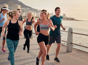 Friends running on the boardwalk