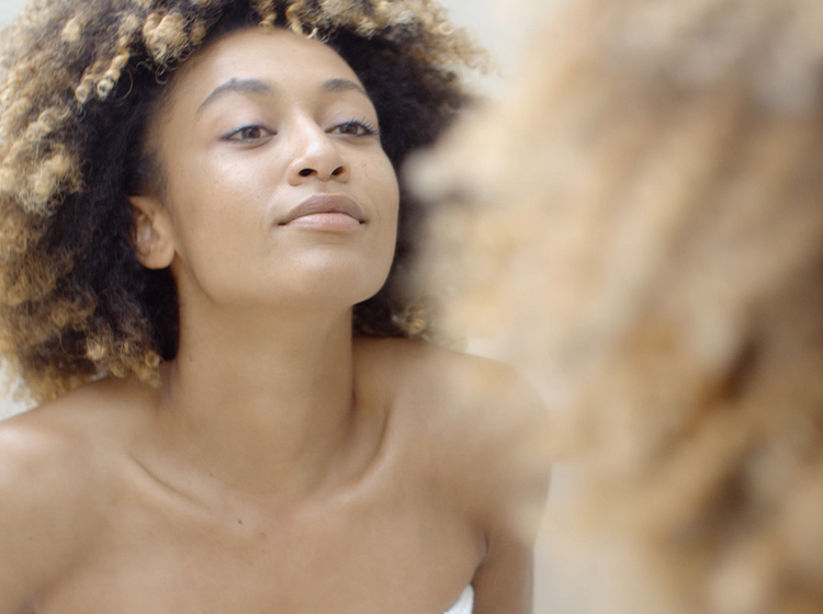 woman looking in mirror
