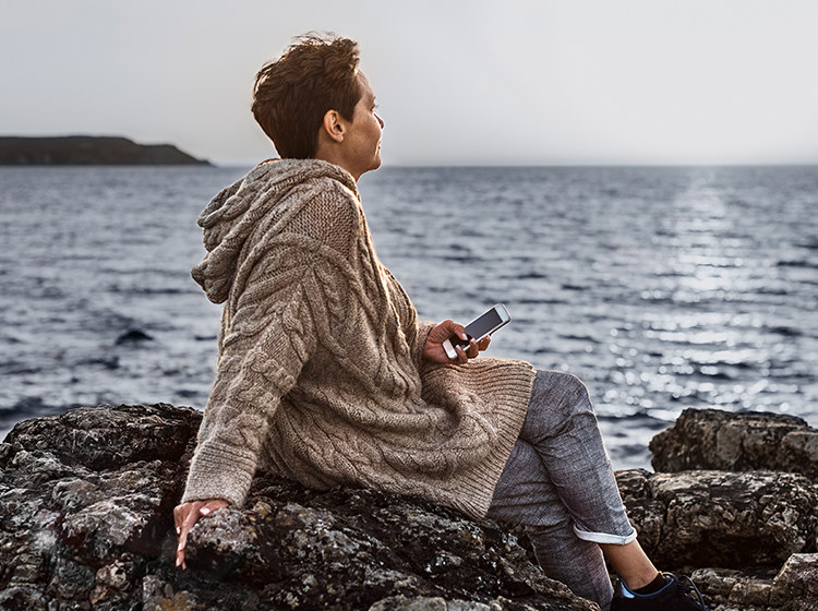 Older woman looking out at the ocean