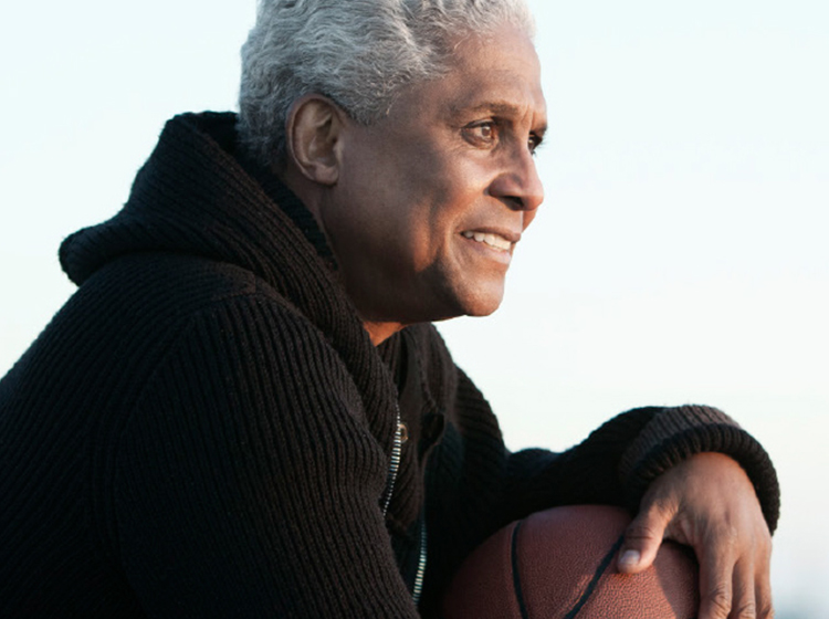 Man standing outdoors with basketball