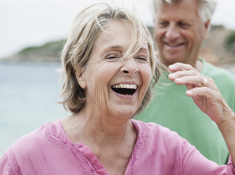 woman laughing with man behind