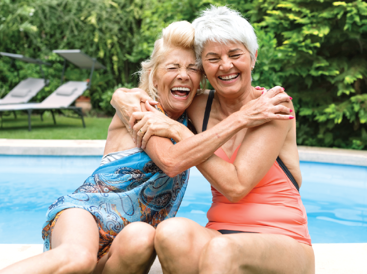 Senior women smiling by the pool