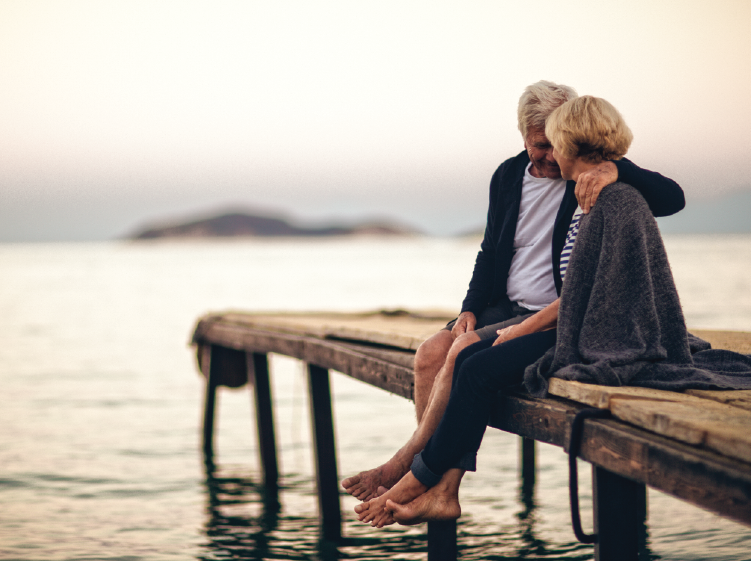 Couple sitting on a boardwalk 