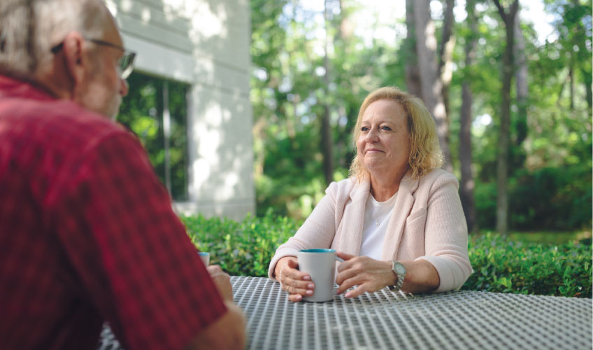an Aetna Medicare customer service representative discussing medicare questions with an older male Aetna Medicare member