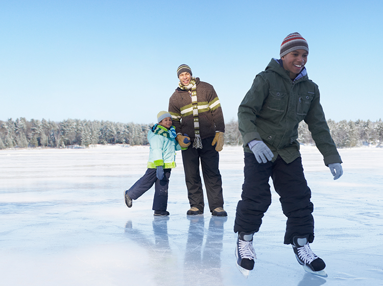 Three people skating on ice